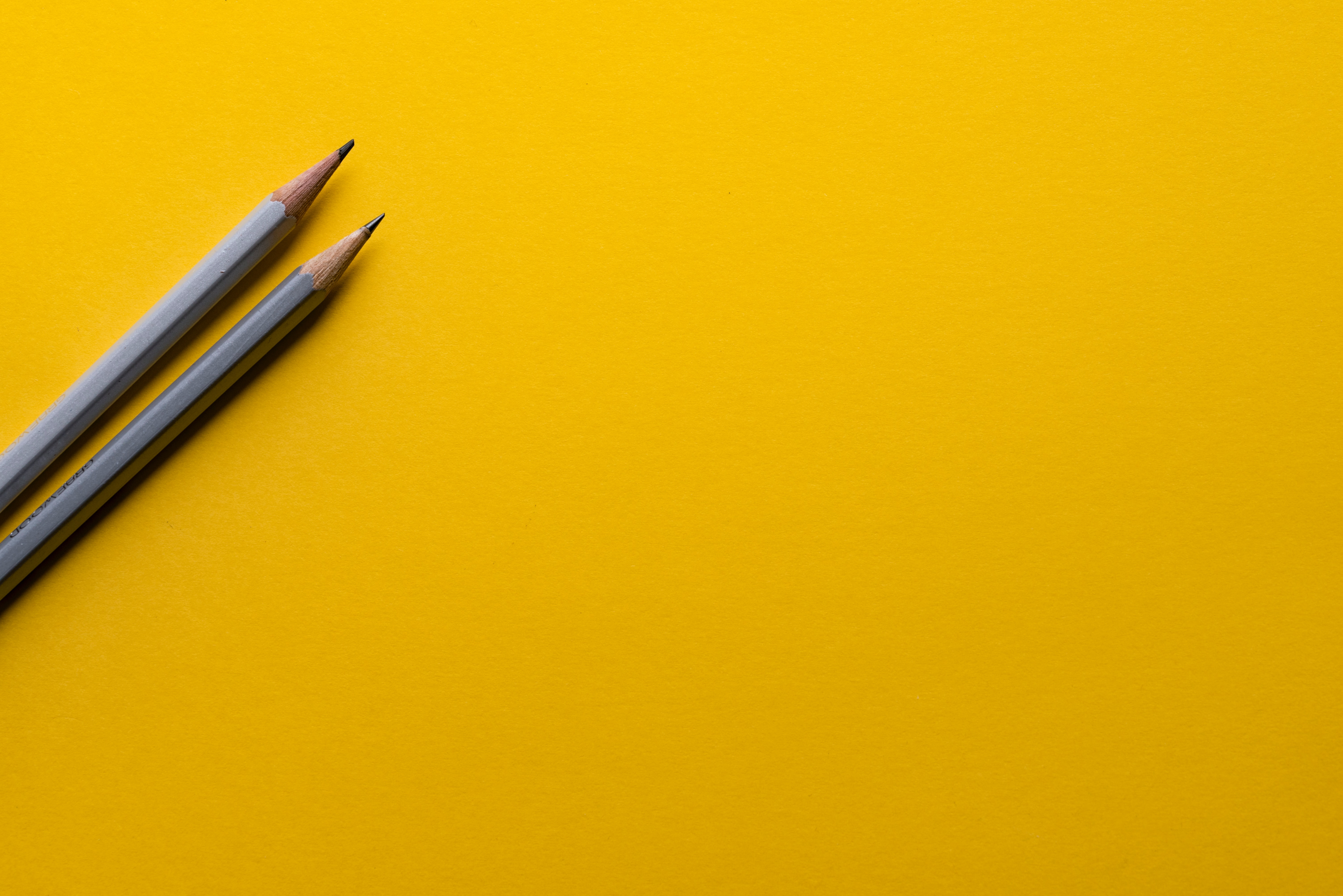 Pencils, yellow background.