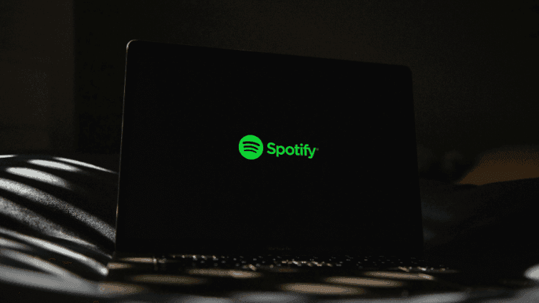 Spotify logo on a dark laptop screen