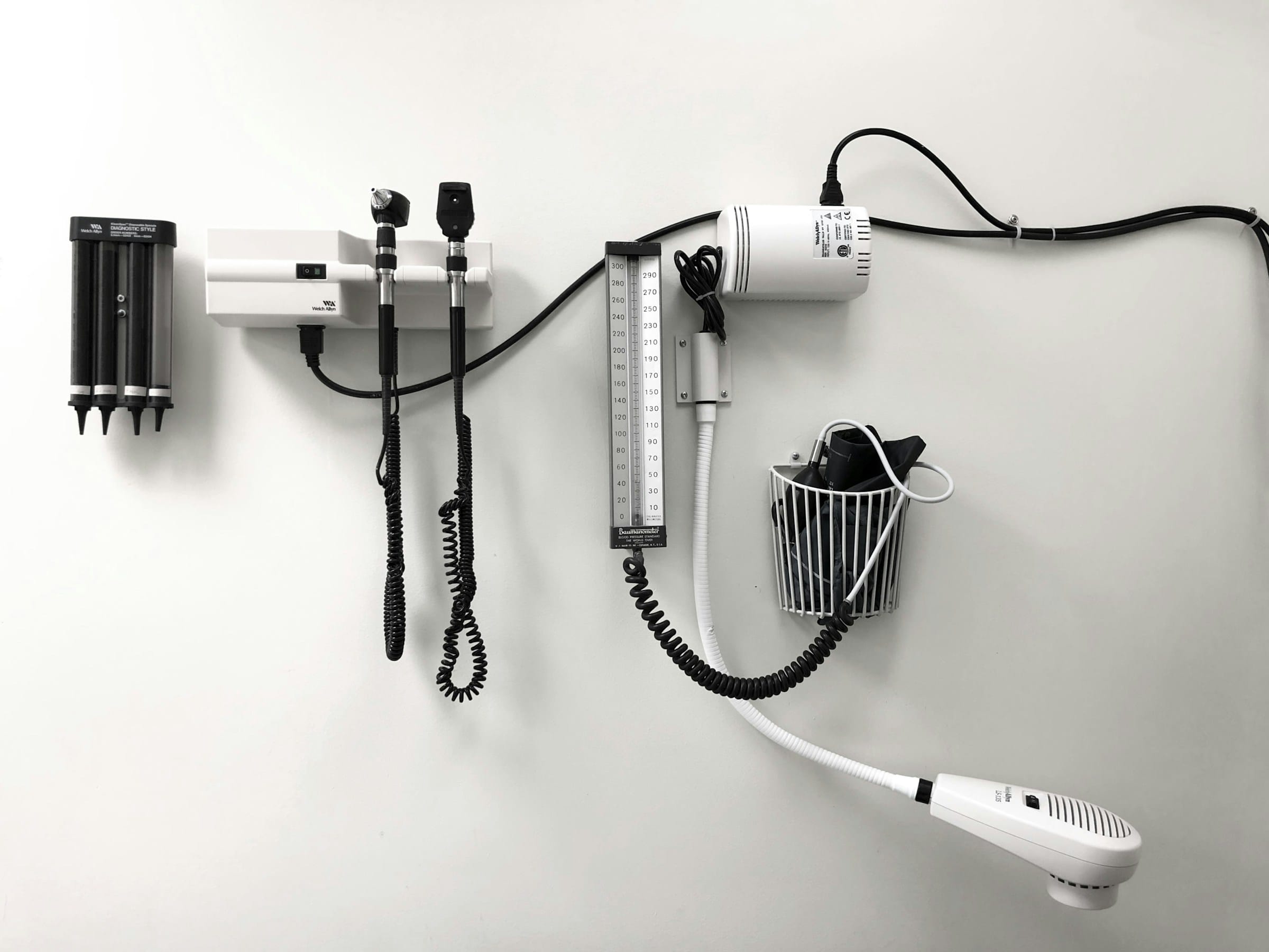 Medical diagnostic equipment on wall, clinical tools.