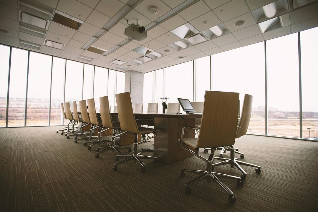 Empty conference room with long table and chairs