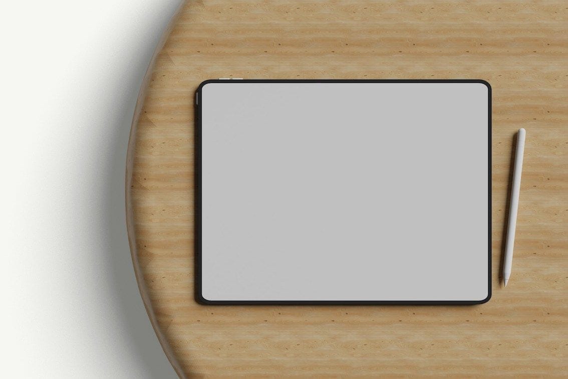 Tablet with stylus on wooden table