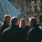 Group gathering outside modern glass building