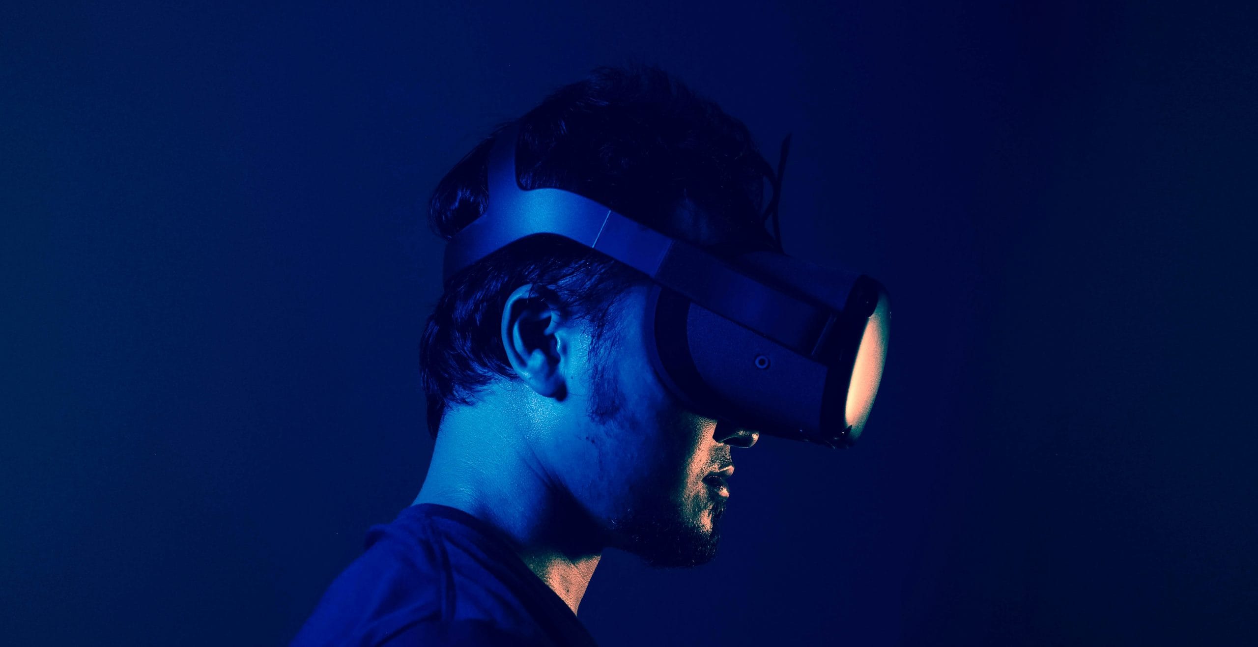 Person wearing virtual reality headset, blue lighting