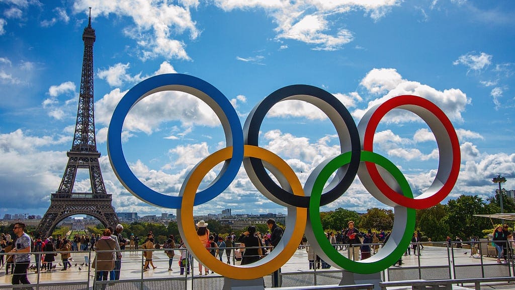 Eiffel Tower behind Olympic Rings, Paris, sunny day.
