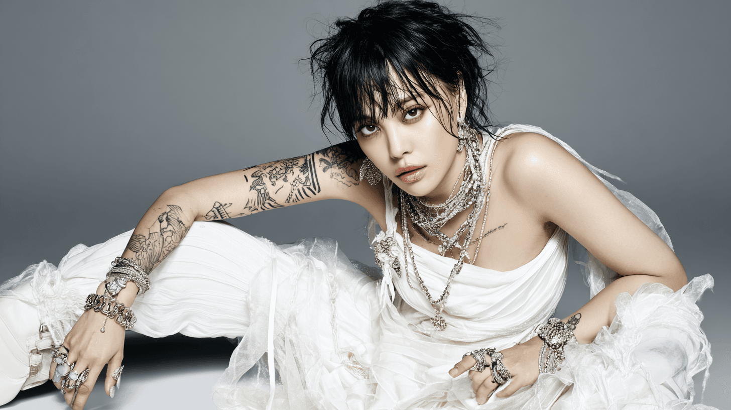 Person with tattoos in elegant white outfit.