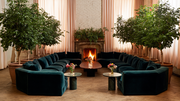 Cozy living room with fireplace and green sofas.