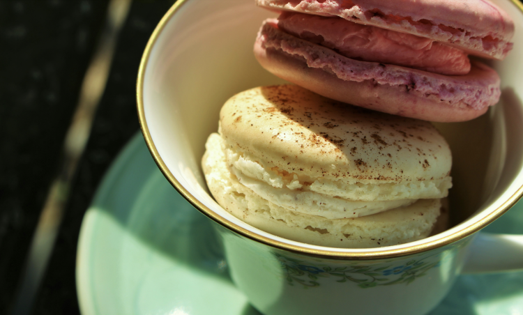 Colorful macarons in elegant teacup