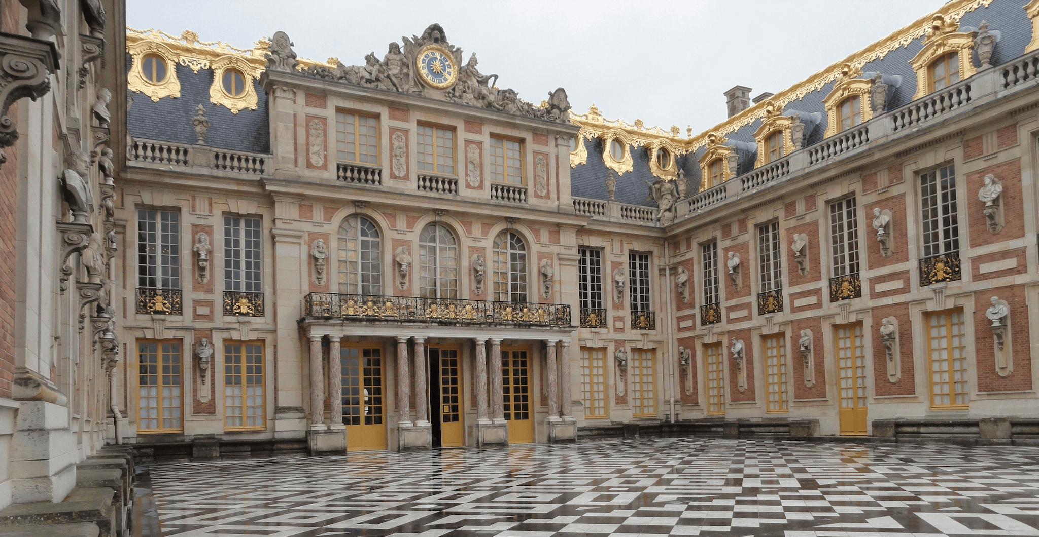 Palace courtyard with ornate architecture and checkerboard floor.