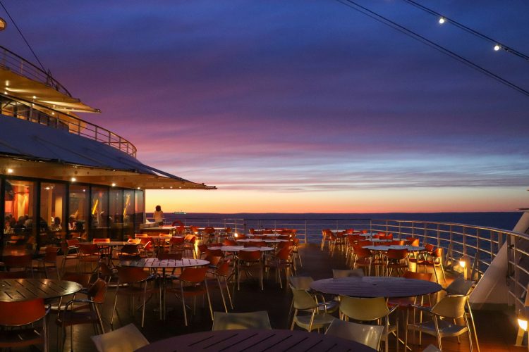 Cruise ship deck with sunset view.