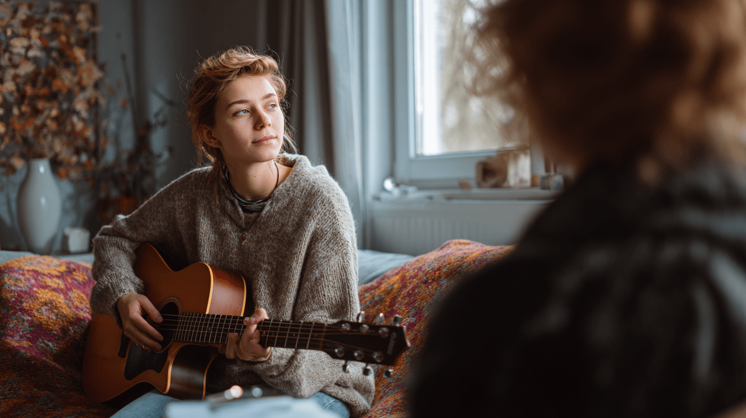 Woman playing acoustic guitar indoors