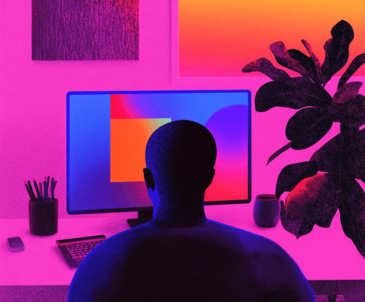 Person at computer with vibrant, colorful screen.
