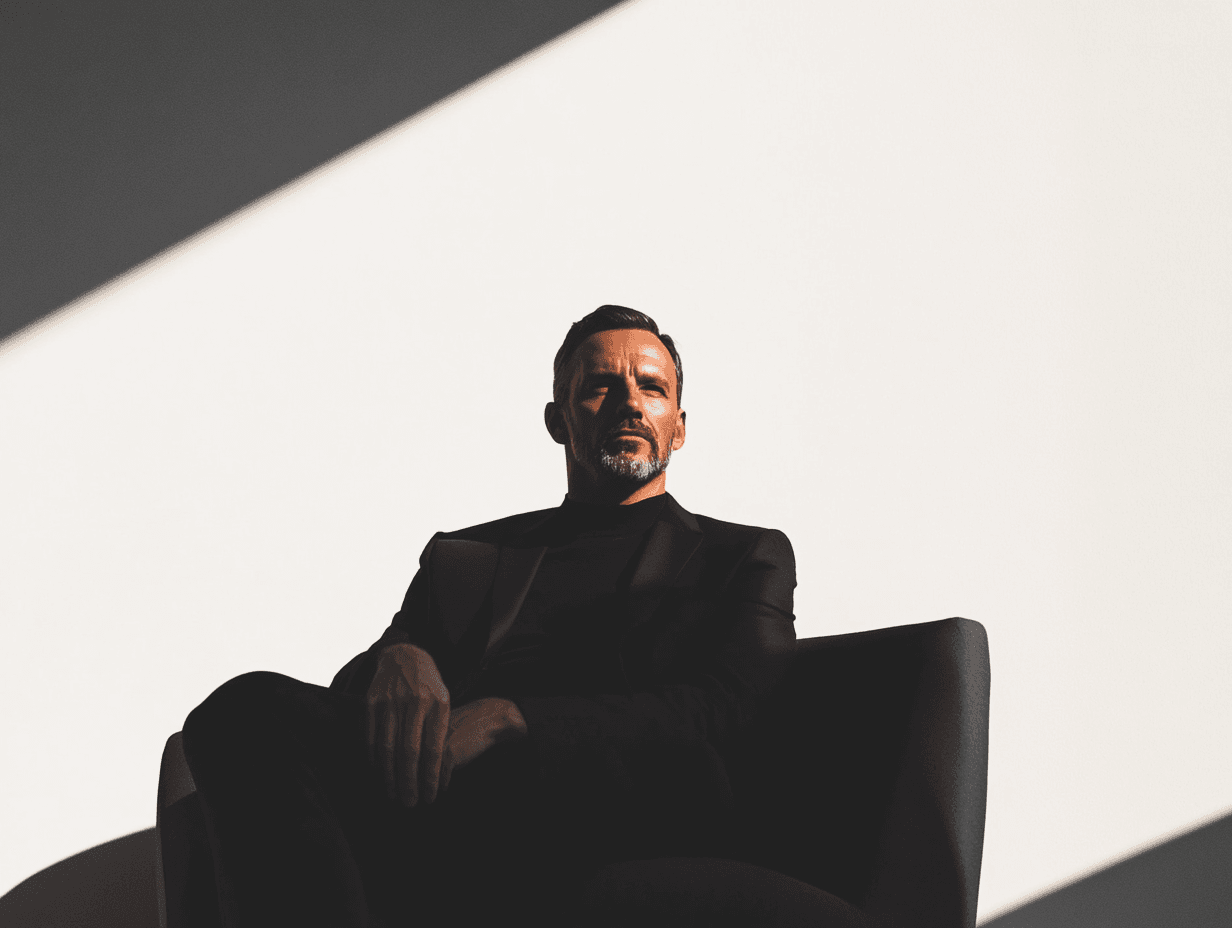 Man in shadowy chair lit by sunlight